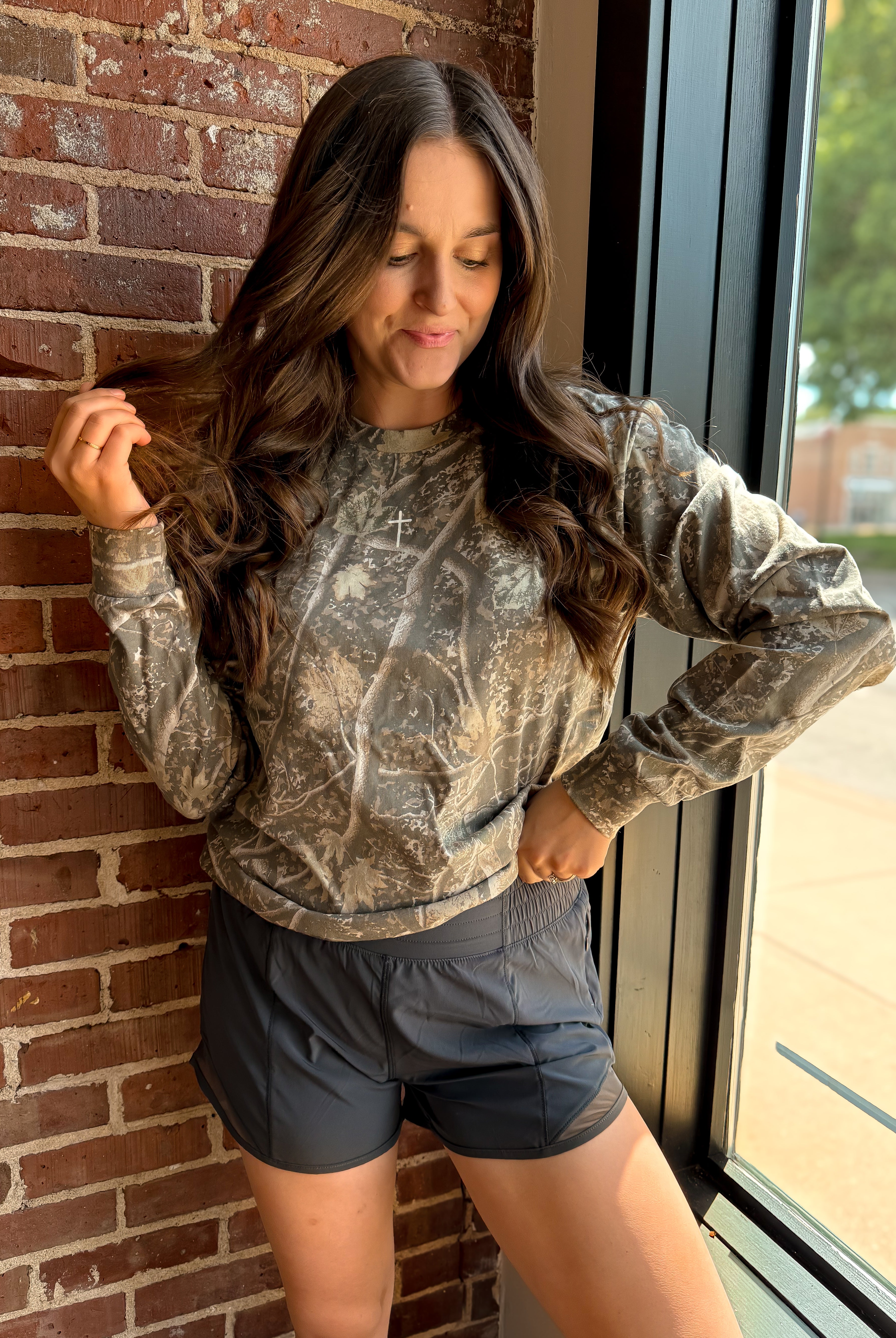 Happiness Trails Boutique - Deadwood Tree Camo Long Sleeve Graphic Tee with a screen printed Small Cross