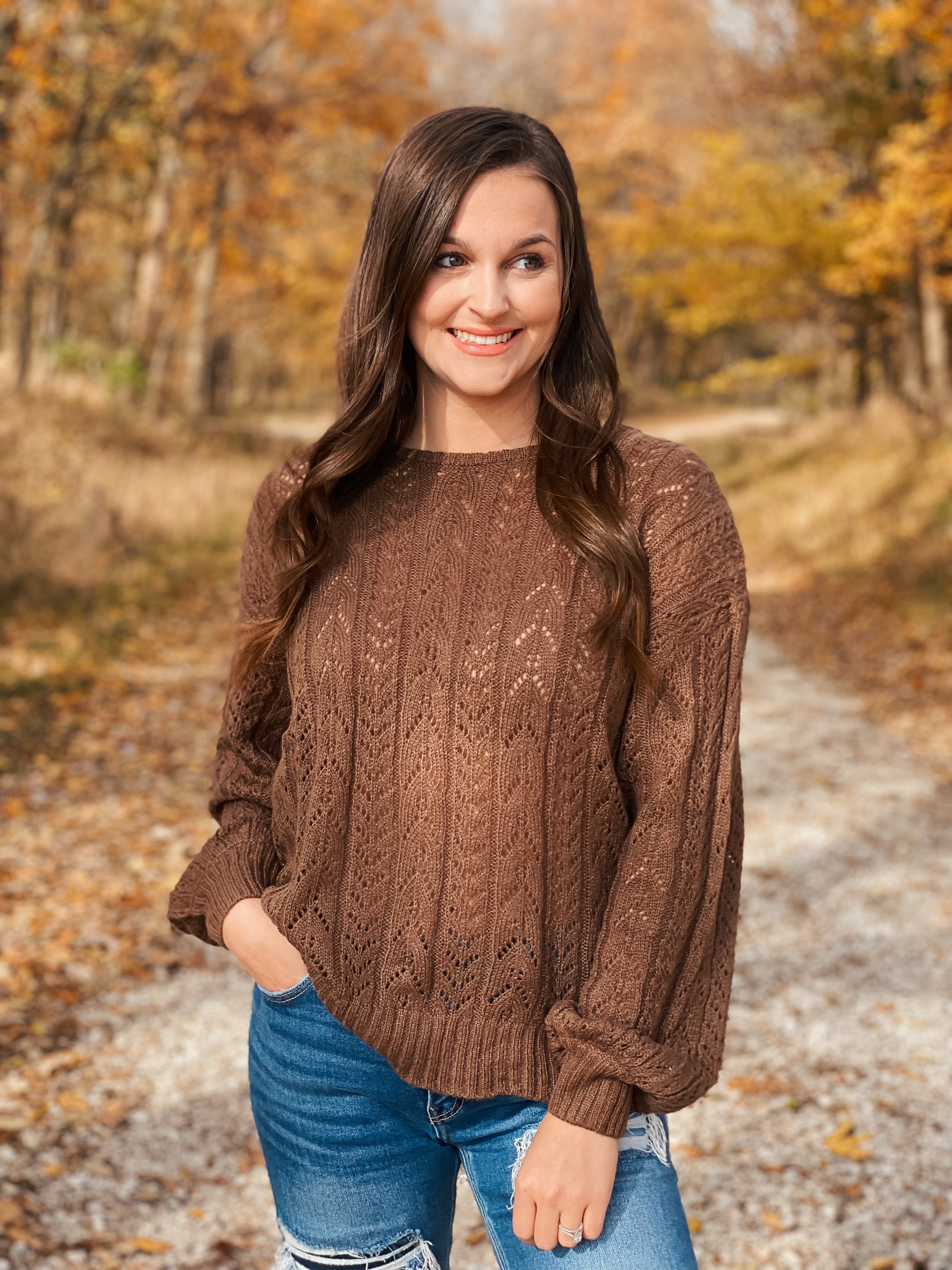 This beautiful brown eyelet sweater is soft and comfortable. The back has a cute bow tie.