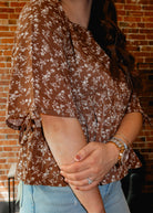 Happiness Trails Boutique - Brown peplum blouse with cream floral print