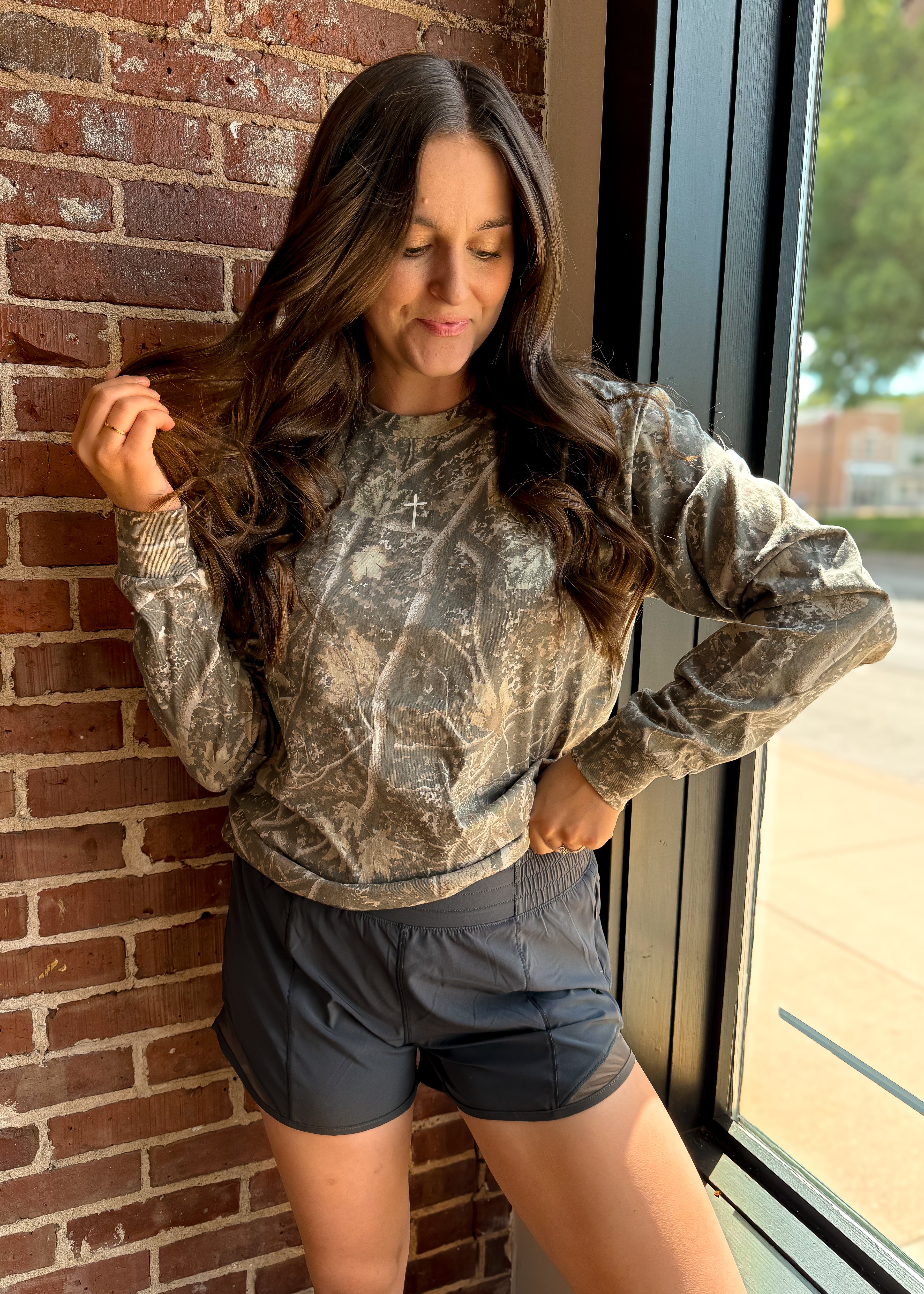 Happiness Trails Boutique - Deadwood Tree Camo Long Sleeve Graphic Tee with a screen printed Small Cross