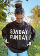 Happiness Trails Boutique - reversible Game Day sweatshirt! Featuring “Game Day” printed on one side and “Sunday Funday” on the reverse, this dark gray sweatshirt