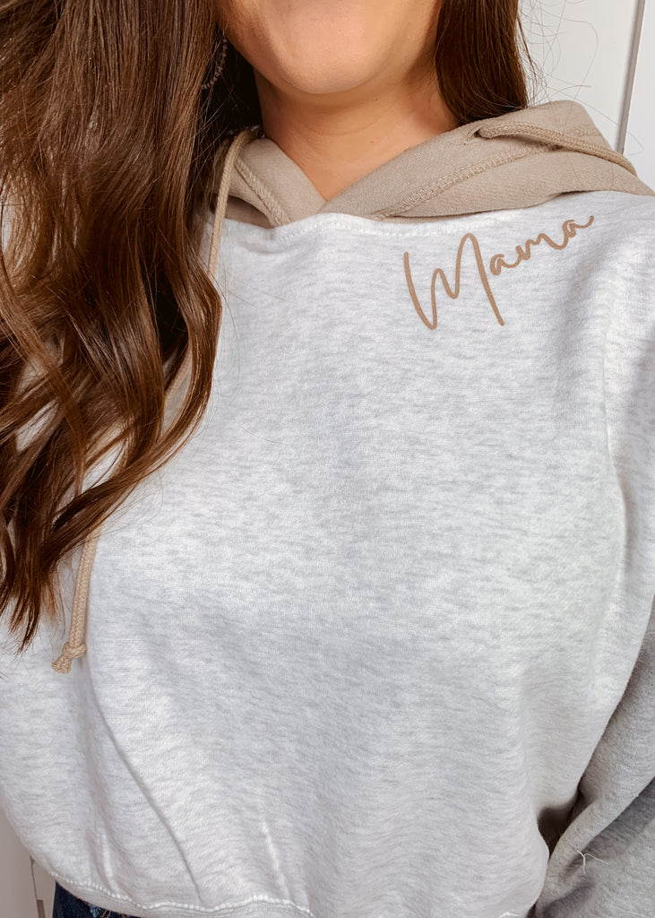 Mama screen printed on a light grey colorblock cropped hooded sweatshirt
