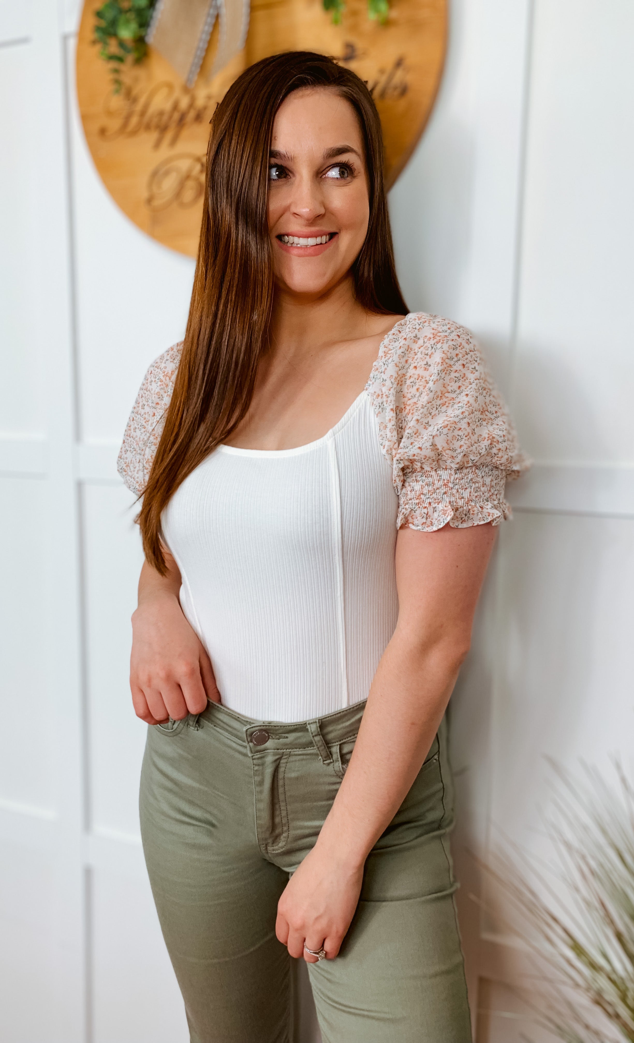white ribbed bodysuit with floral sleeves