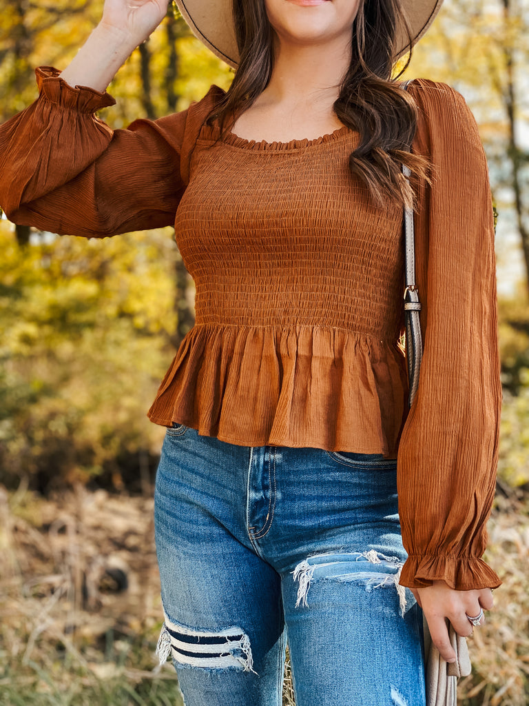 This smocked peplum top is adorable in the camel color.